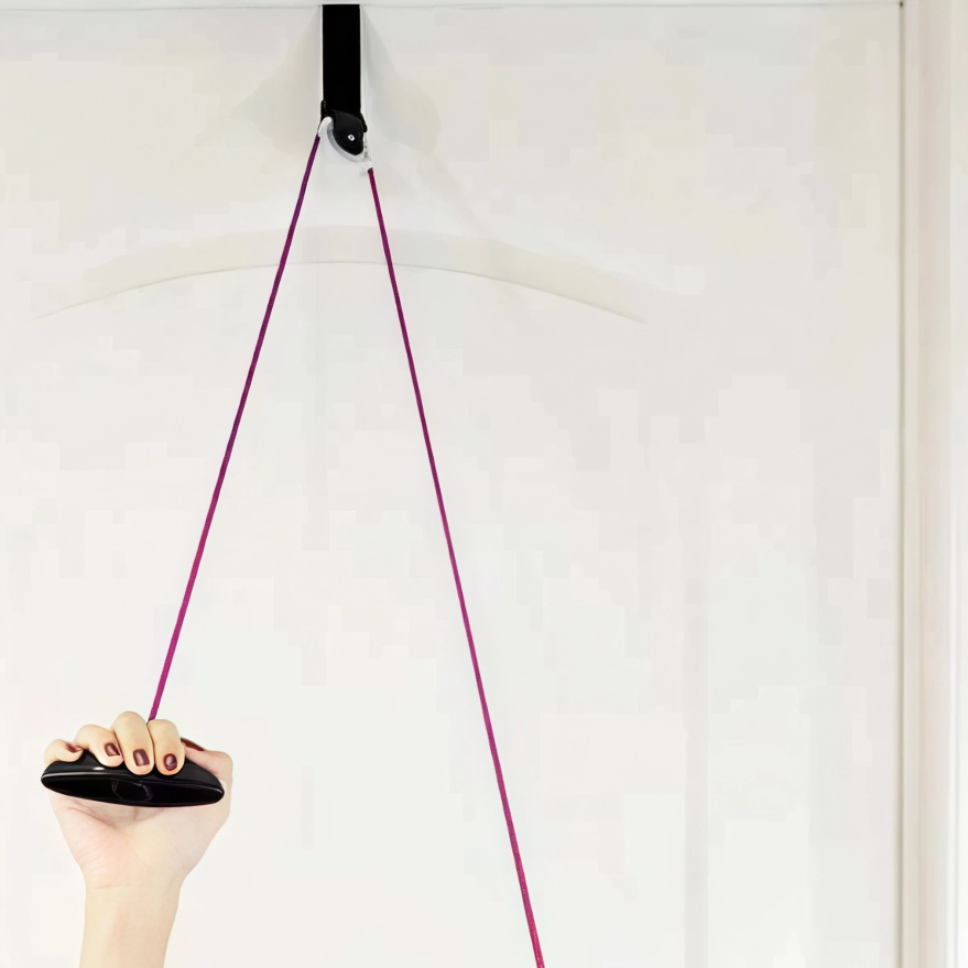 Hand using a door-mounted pulley exercise system for shoulder rehab and mobility